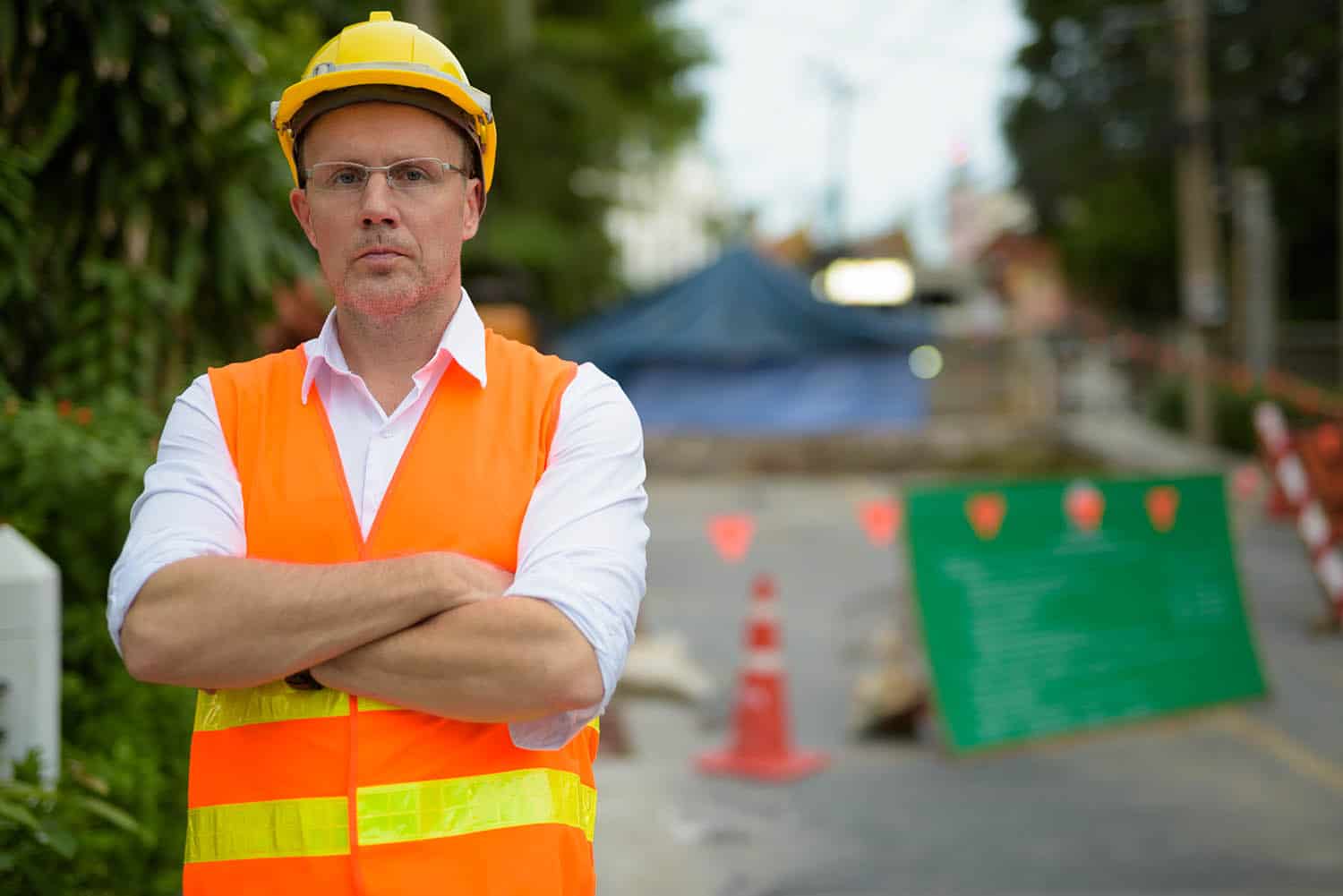 Mature man construction worker at the construction site in the c